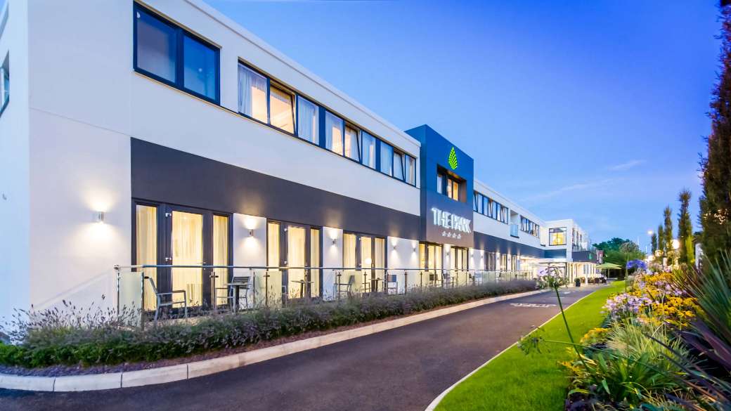 Park Hotel External View with Flowers Evening Time