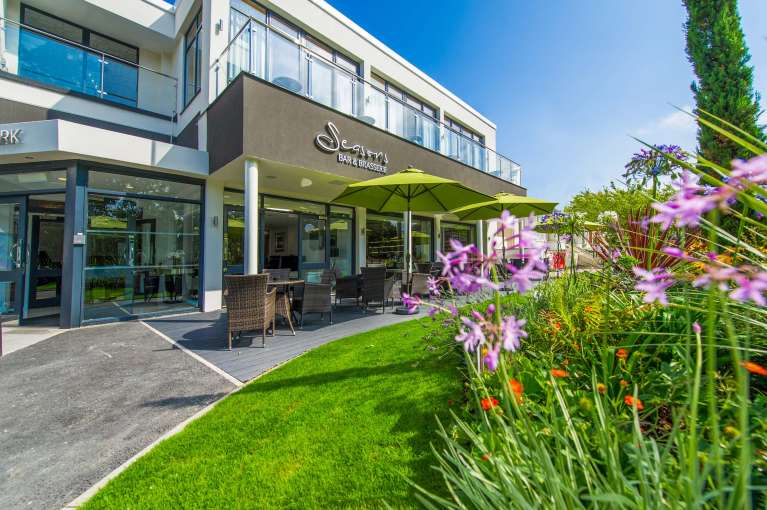 Park Hotel Seasons Bar and Brasserie External View with Outdoor Seating and Flowers